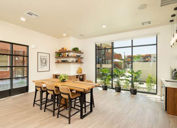 A modern dining room with a wooden table and chairs.