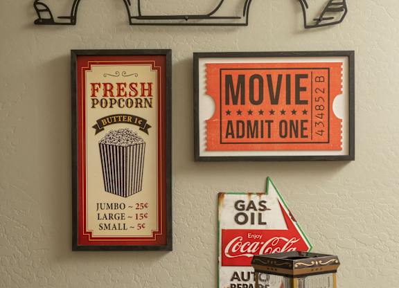 A wall with a car cutout, a movie ticket, a popcorn sign, a gas oil sign, and a Coca-Cola sign.