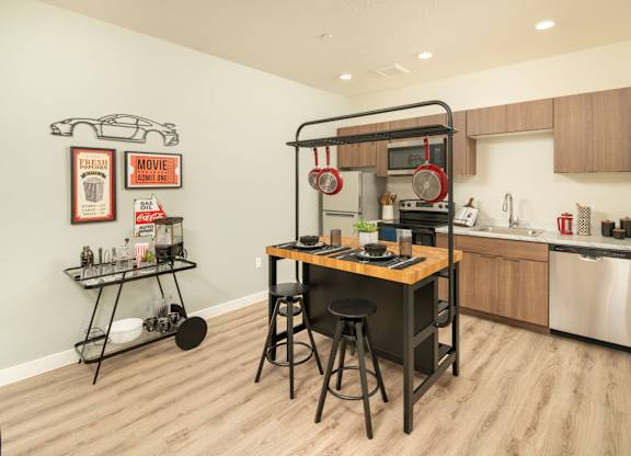 A kitchen with a table and chairs in the middle of the room.