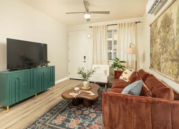 A living room with a brown couch and a green cabinet.