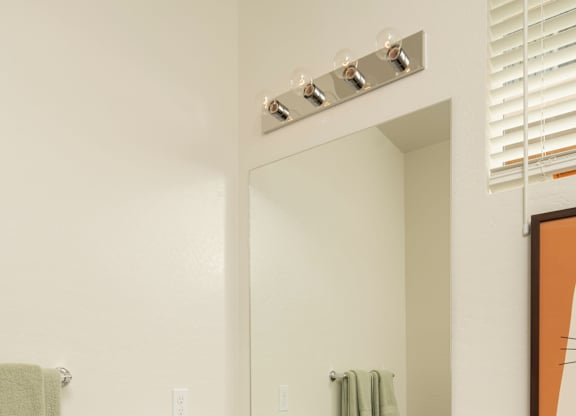 A bathroom with a sink and a towel hanging on the wall.