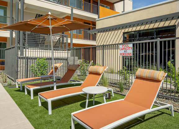 A sunny day at the outdoor seating area of a modern building.