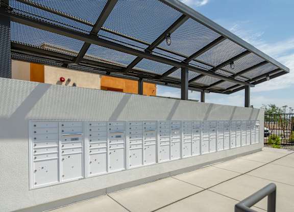 A row of mailboxes are lined up on a wall.