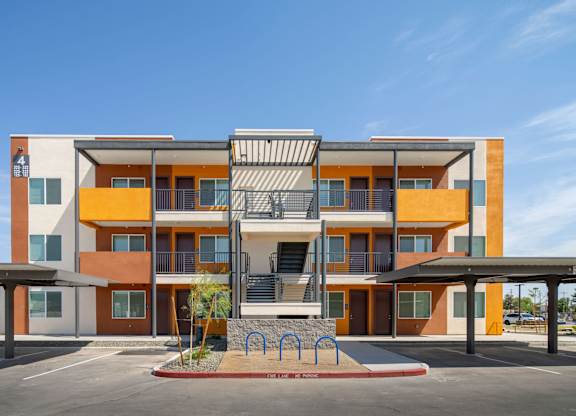 A modern apartment building with a playground in front.