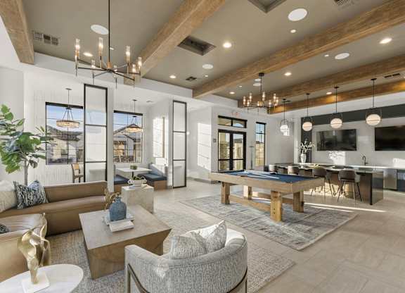 A modern living room with a large couch, a coffee table, and a TV.