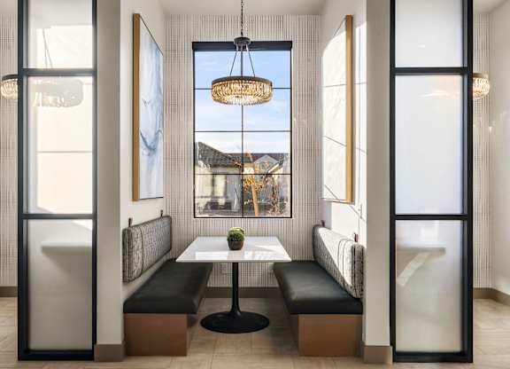 A modern dining room with a table and chairs.