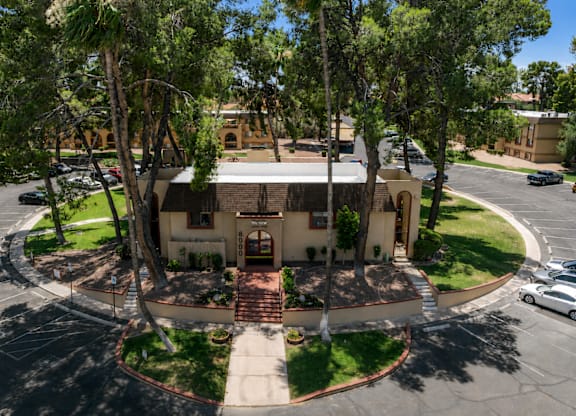 A house with a circular driveway and a white car parked in front.