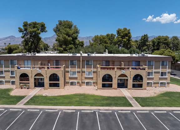 A large building with a parking lot in front of it.