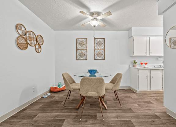 A dining room with a table and chairs.