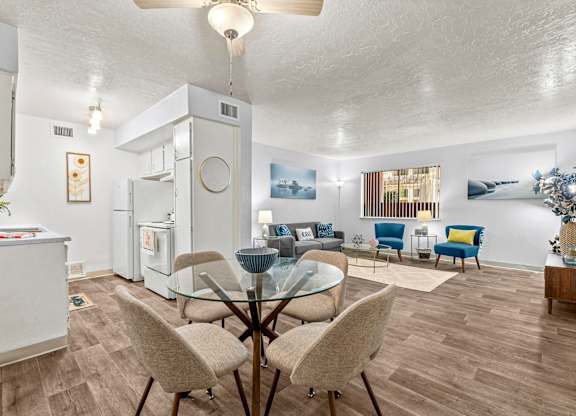 A modern kitchen with a dining table and chairs.