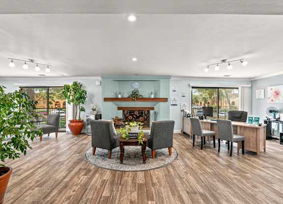 A living room with a fireplace and grey chairs.