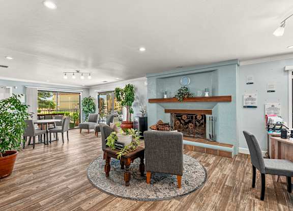 A living room with a fireplace and a dining table.