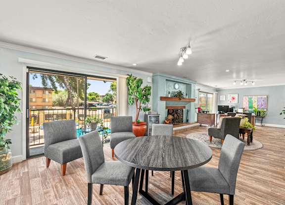 A dining room with a table and chairs.