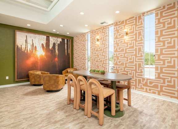 A dining room with a wooden table and chairs.