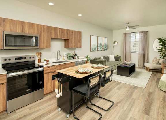 A modern kitchen with a wooden cabinet and a black stove top oven.