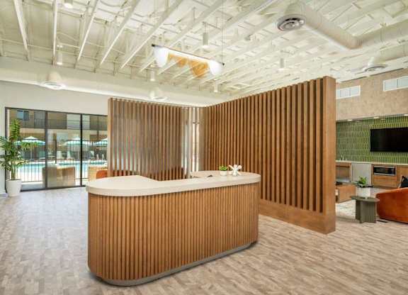 A reception area with a wooden reception desk and a white ceiling.