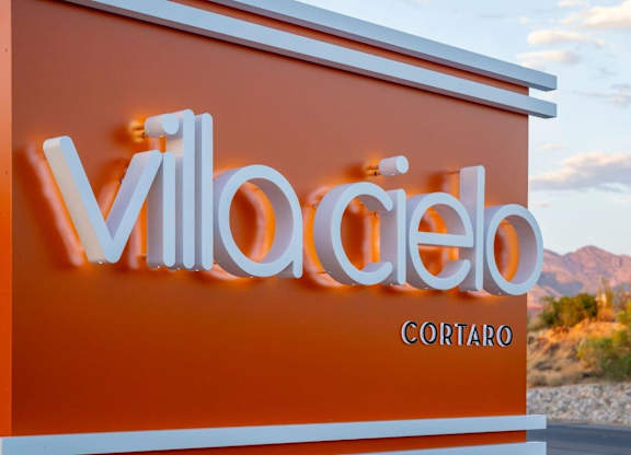 A sign with the word "VillaCielo" in white letters on an orange background.