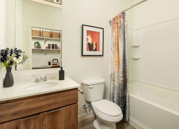 A white toilet sits next to a sink in a bathroom.