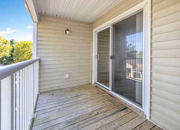 A deck with a sliding glass door leading to a balcony. at Ardenwood Apartments, North Haven, CT