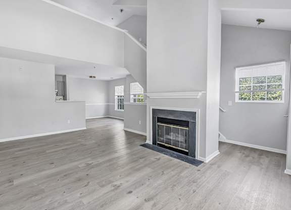 A spacious living room with a fireplace and hardwood floors. at Ardenwood Apartments, Connecticut, 06473