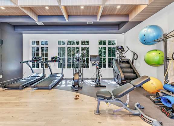 A gym with treadmills, exercise balls, and weights. at Ardenwood Apartments, North Haven