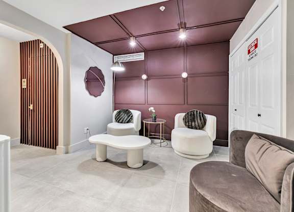 a living room with couches and chairs and a door at The Meriden, Meriden Connecticut