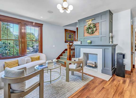 A living room with a fireplace and a couch. at Ardenwood Apartments, North Haven, CT
