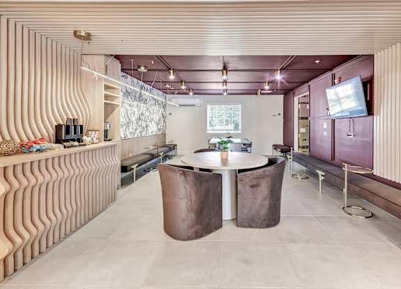 a dining room with a table and a tv at The Meriden, Meriden, 06450
