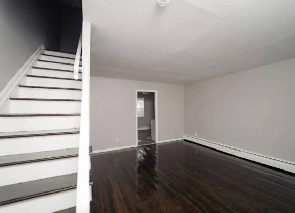an empty living room with stairs and a white staircase at Encore 99, East Haven, CT, 06512