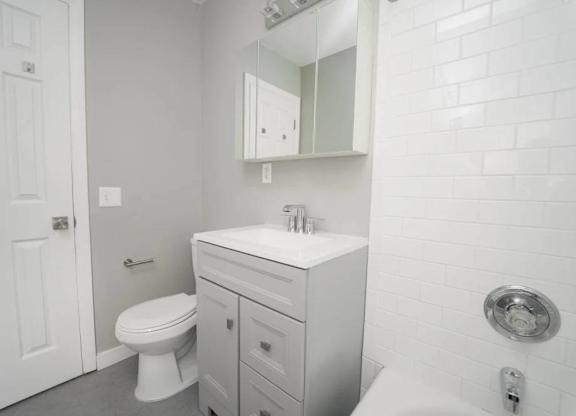 a white bathroom with a sink and a toilet at Encore 99, Connecticut, 06512