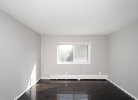 an empty room with white walls and a window at Encore 99, Connecticut, 06512