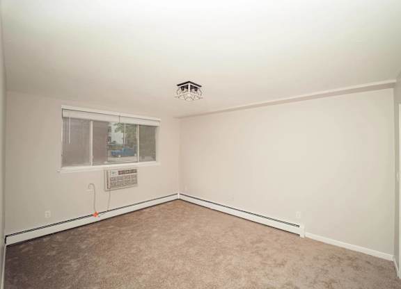 a empty room with a window and a ceiling fan at Five High, West Hartford, Connecticut