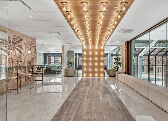 a large lobby with a row of lights on the ceiling at Up House, Farmington, 06032
