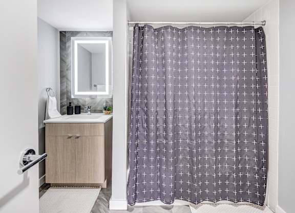 a bathroom with a shower curtain and a sink at Up House, Farmington, Connecticut