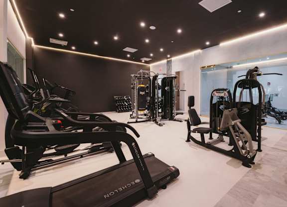 a gym with treadmills and other exercise equipment on a white floor at Up House, Farmington, Connecticut