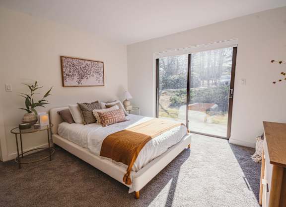 a bedroom with a bed and a sliding glass door at Up House, Farmington