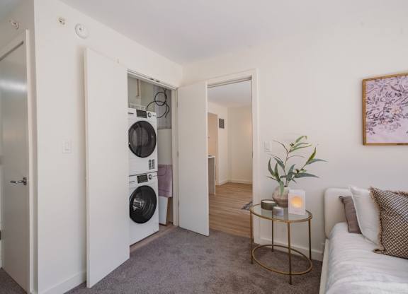 a living room with a washing machine and a dryer in it at Up House, Farmington, 06032
