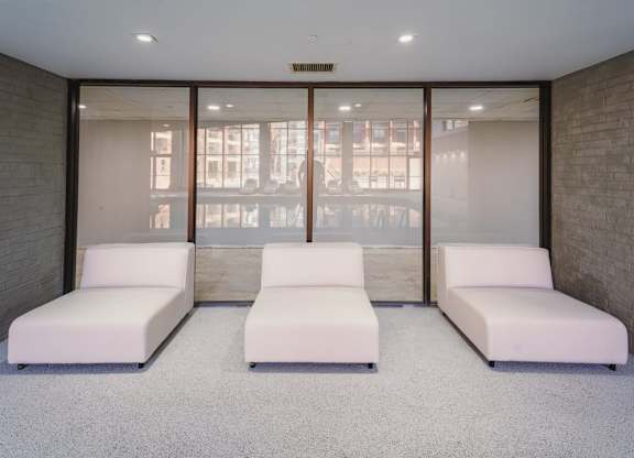 a room filled with white couches and a window at Up House, Farmington
