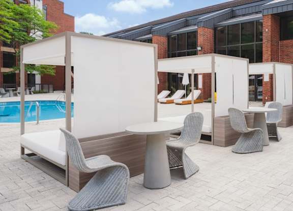 a patio with tables and chairs and a pool at Up House, Farmington, Connecticut