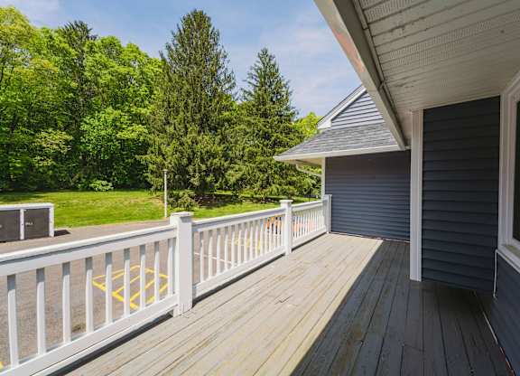 a deck with a view of a yard and a house at Woodbury Knoll, Connecticut