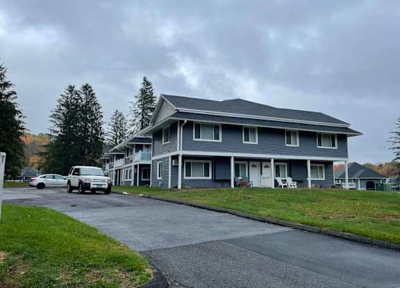 a blue house with cars parked in front of it at Woodbury Knoll, Woodbury