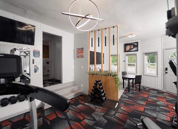 a living room that has a gym and a dining area with a table and chairs at Woodbury Knoll, Woodbury