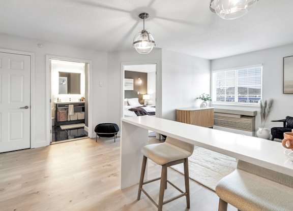 an open kitchen and living room with a white counter top at The Meriden, Meriden