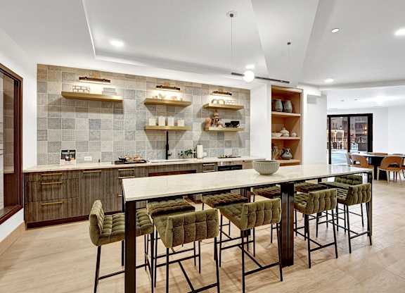 A modern kitchen with a dining table and chairs.