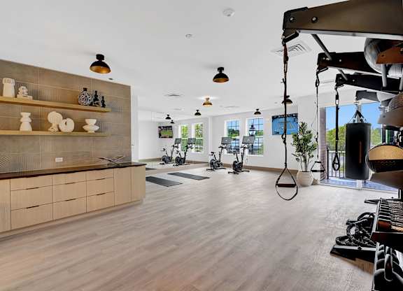 A modern kitchen with wooden floors and a large island.