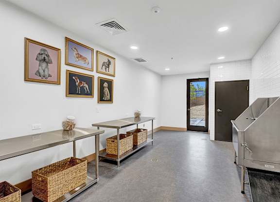 A kitchen with a long counter and pictures on the wall.