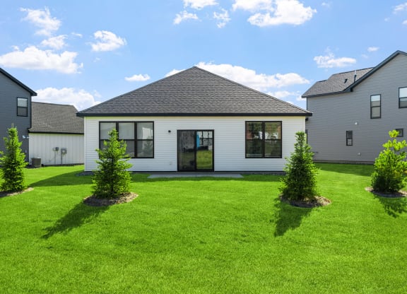 a white house with a yard in front of it