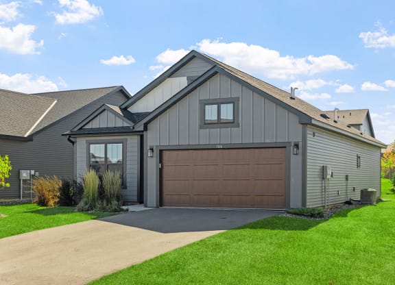 a house with a garage door and a driveway