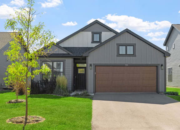 a house with a brown garage door and a driveway