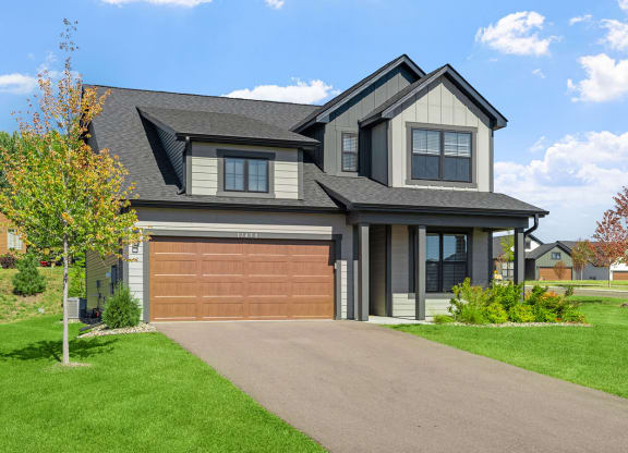 a house with a garage door and a driveway